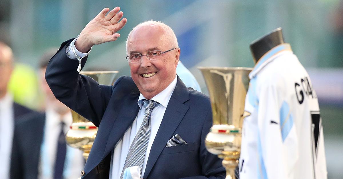 Sven-Goran Eriksson waving in a suit and tie. 