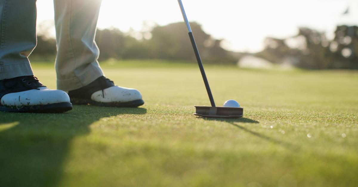 A man putting a golf ball