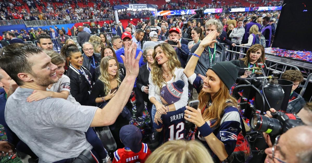 Tom Brady high fiving sister Julie in 2019