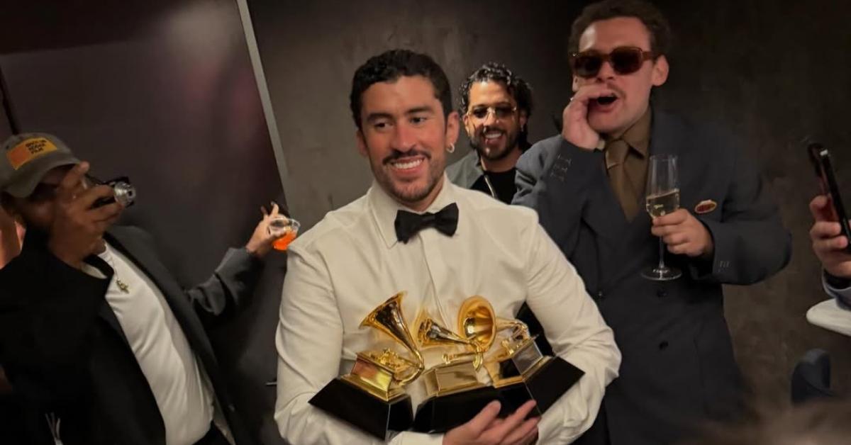 Bad Bunny holding his Grammys.