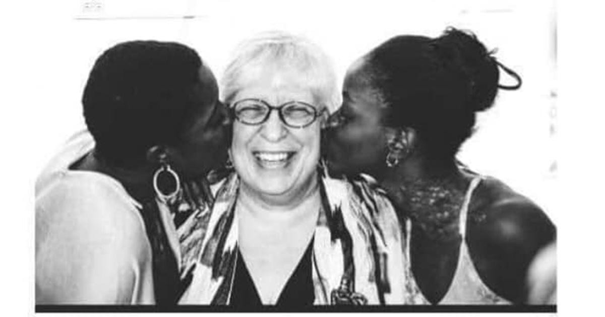 Elaine DePrince being kissed on the cheek by Mia and Michaela DePrince