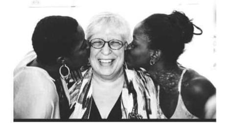 Elaine DePrince being kissed on the cheek by Mia and Michaela DePrince