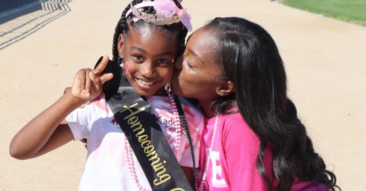 Da'Vonne Rogers kisses her daughter, who has a Homecoming sash and crown