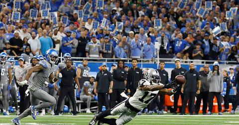Lions fans holding 3s during a game against the Raiders.