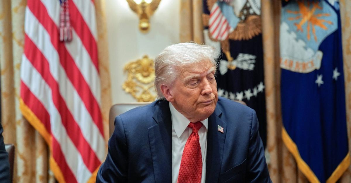 Trump sits in a meeting in what appears to be the Oval Office at the White House.