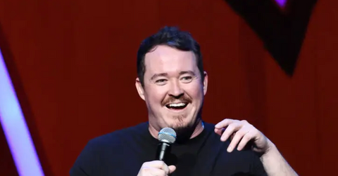 Shane Gillis performs stand-up on stage