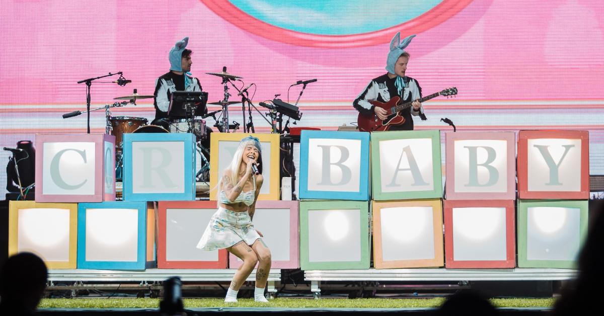 melanie martinez performing at lollapalooza with crybaby blocks behind her