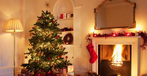 Christmas tree with gifts near fireplace