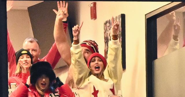 Taylor Swift wearing a white jacket at a chiefs game