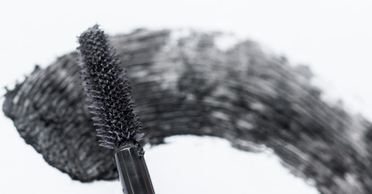 An image of a mascara wand with a swatch on a piece of paper