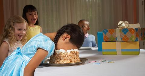 Birthday girl with her face in a cake