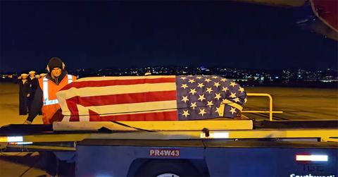 Kenra McDaniel's casket arriving in the United States.