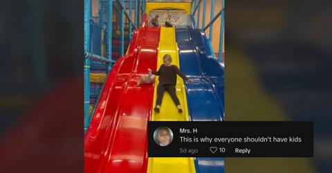 A baby and mom struggling on a giant slide