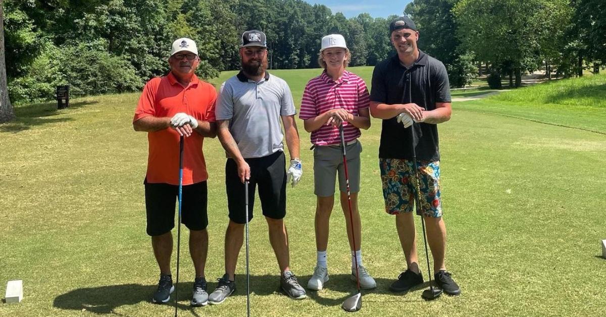 Bentley on a golf course with Ryan and other men in the family