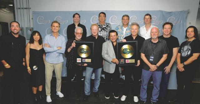 Members of Chicago pose with awards