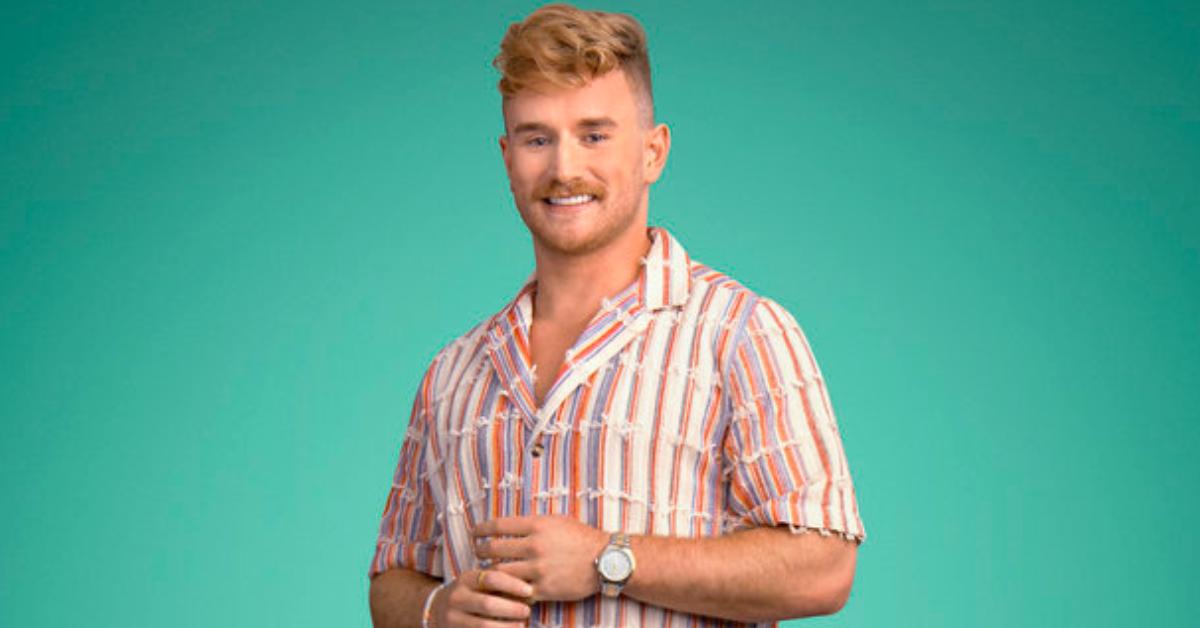 West Wilson smiles and poses for Season 8 of 'Summer House' in a vintage stripe shirt with fraying.