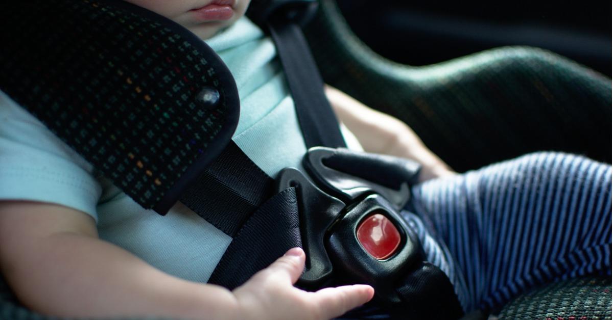 baby in rear facing car seat has the safety belt on picture id