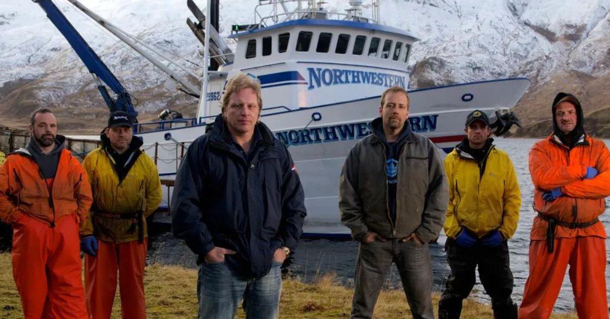 The crew of the Northwestern stand in front of the vessel