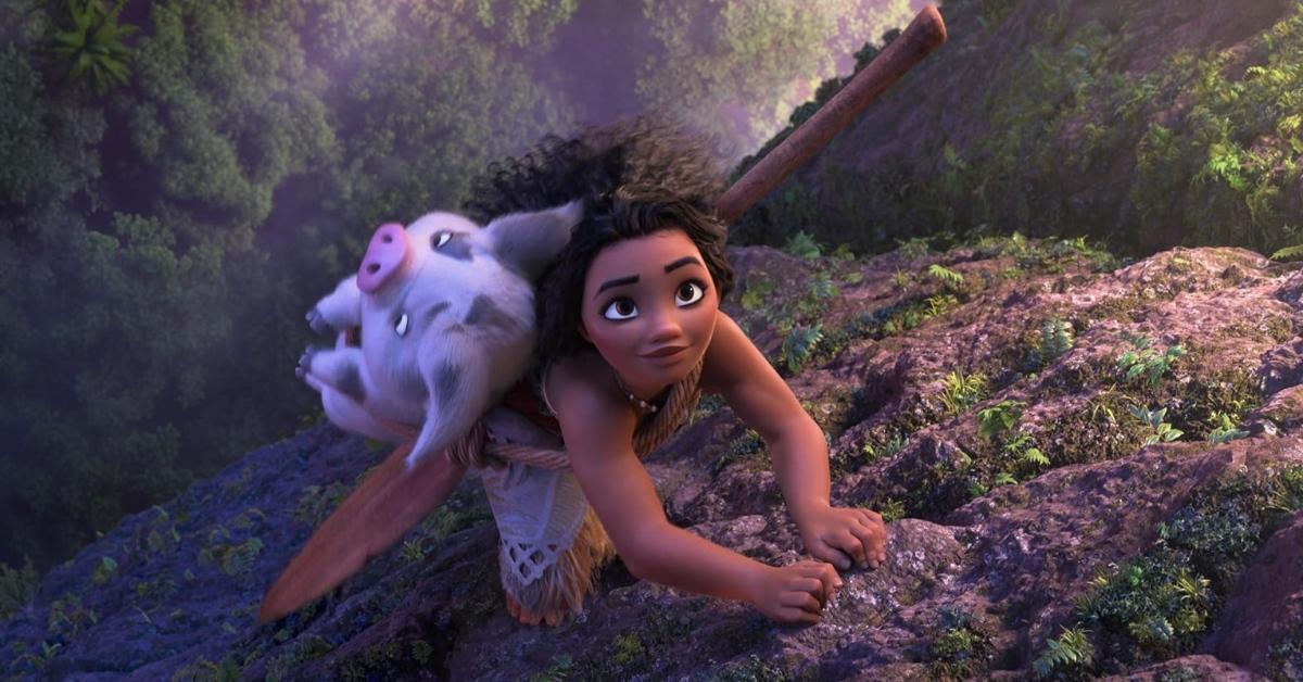 Moana and her pet pig climbing a mountain in 'Moana 2'