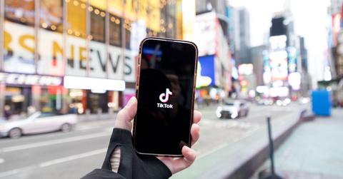 The TikTok logo on a phone screen.
