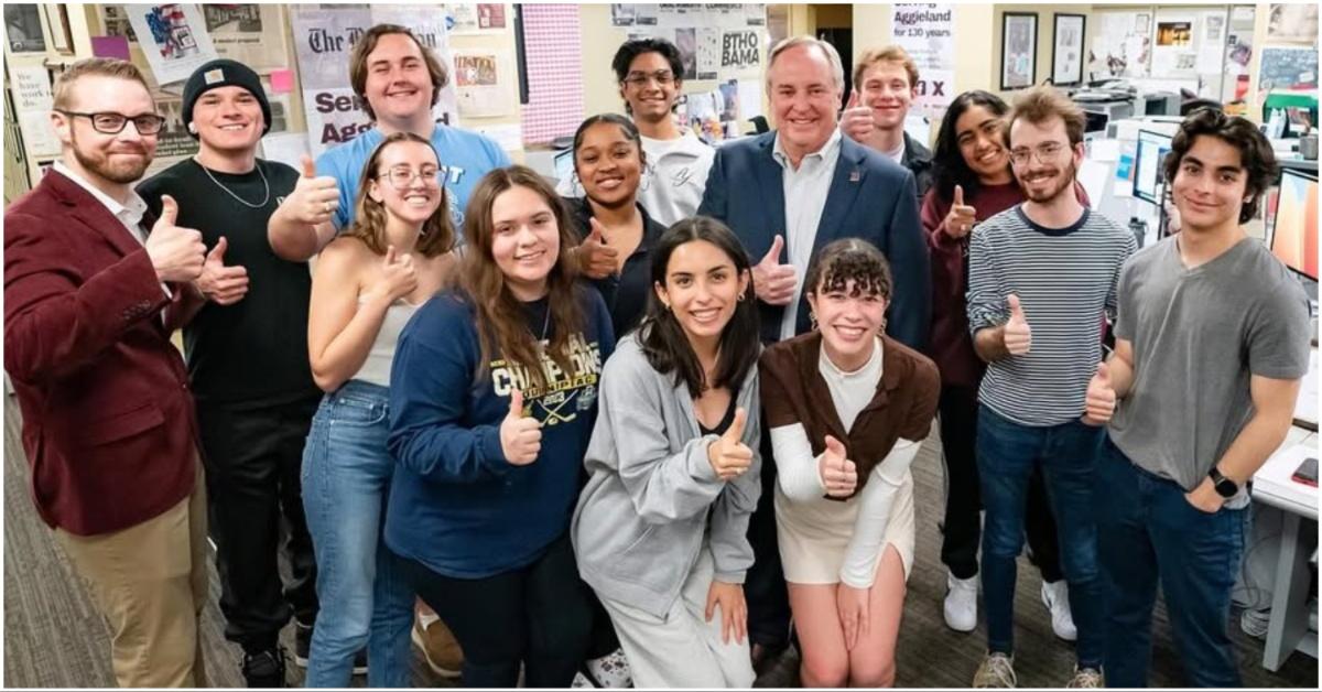 Mark Welsh posing for a photo with students