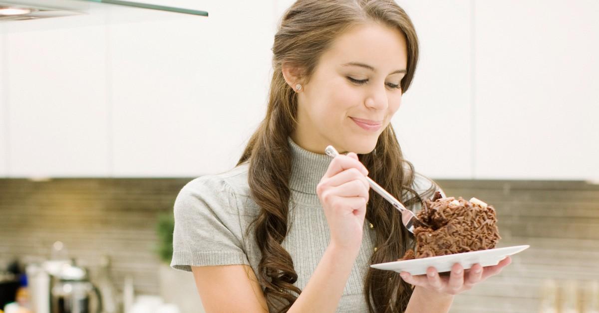 A woman eats a cake 