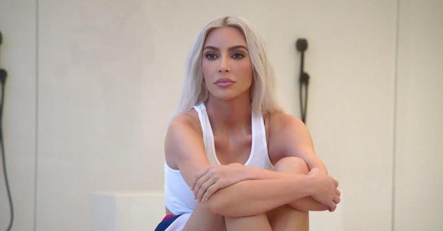 Kim Kardashian sitting with her arms and legs crossed in Season 3 of 'The Kardashians'