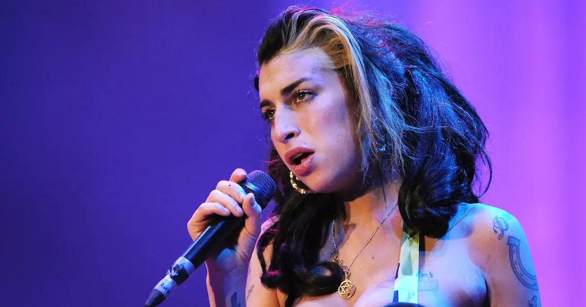 Amy Winehouse performing on stage.