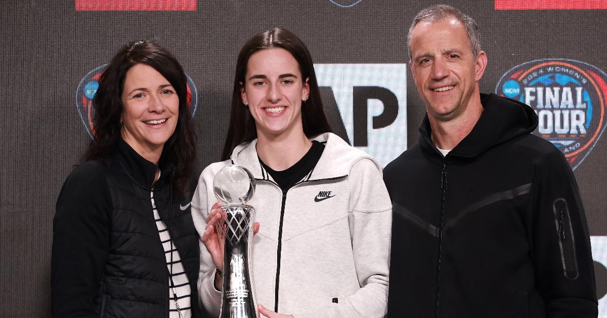 AP Player of the Year Caitlin Clark #22 of the Iowa Hawkeyes poses with her award and parents Anne Nizzi Clark (L) and Brent Clark (R) during a press conference ahead of the 2024 NCAA Women's Basketball Tournament Final Four at Rocket Mortgage Fieldhouse on April 04, 2024 in Cleveland, Ohio. (Photo by Gregory Shamus/Getty Images)