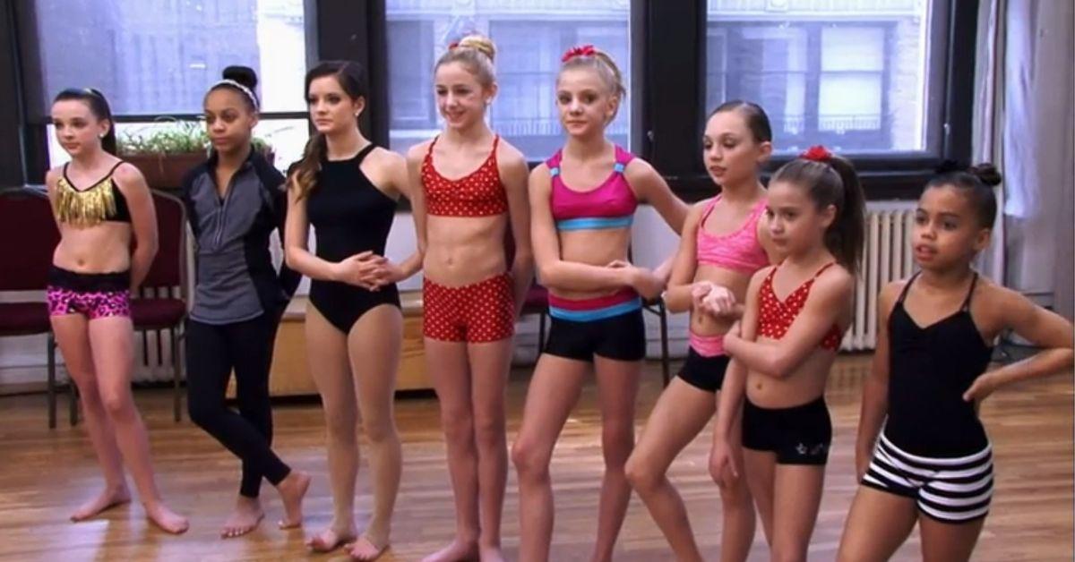 Eight girls on the dance team stand and await instruction on 'Dance Moms'