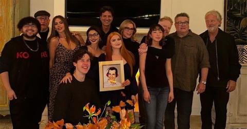 The cast of 'Modern Family' holding a picture of Phil, played by Ty Burrell.
