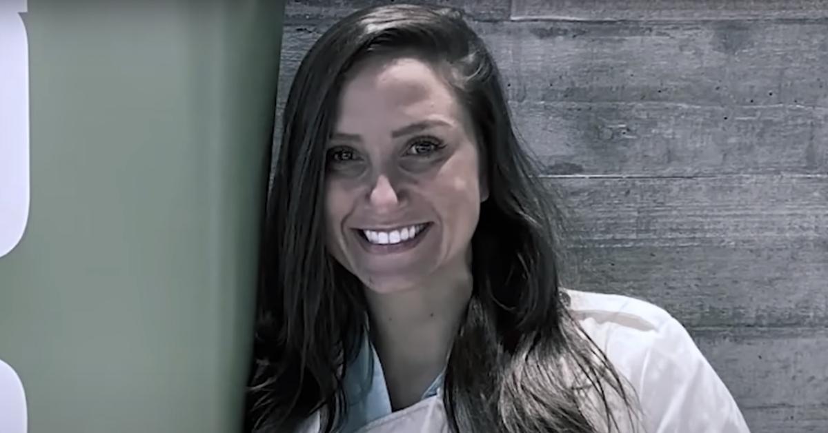 Kouri Richins smiles while standing in front of a wall