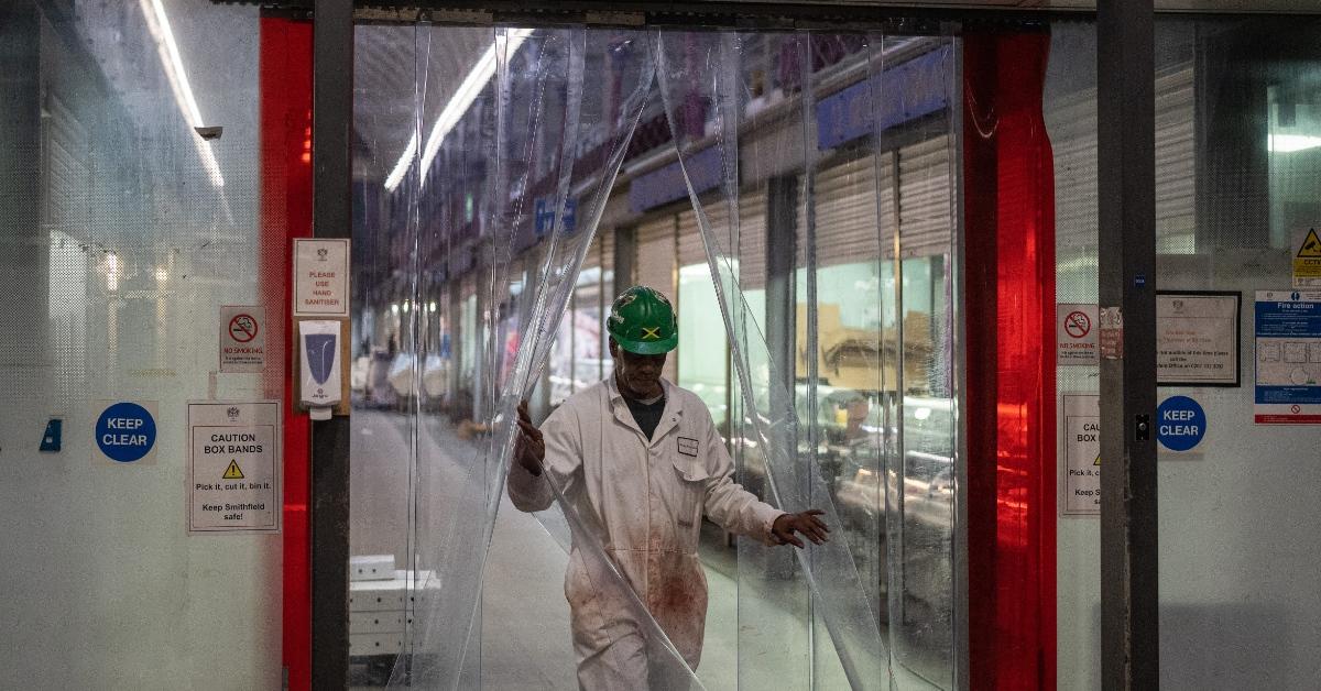 A worker exits a trading hall at Smithfield Market on Feb. 15, 2023 in London, England