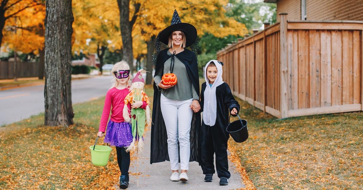 Children trick or treating with an adult