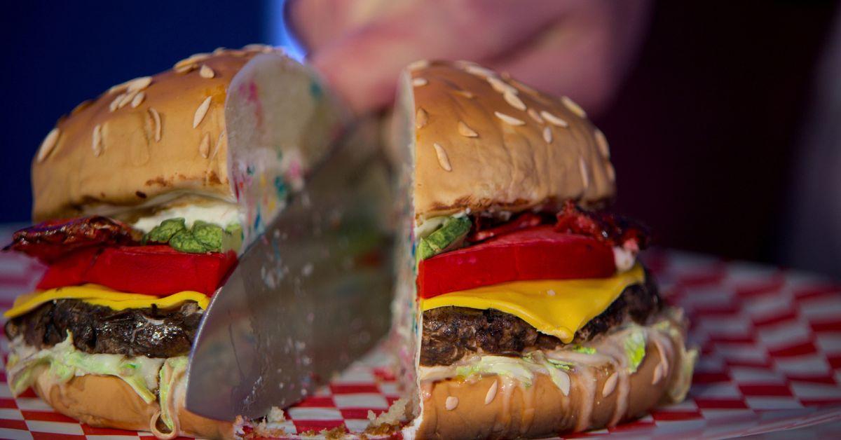 A cheeseburger cake cut by Mikey Day during an episode of 'Is It Cake?'