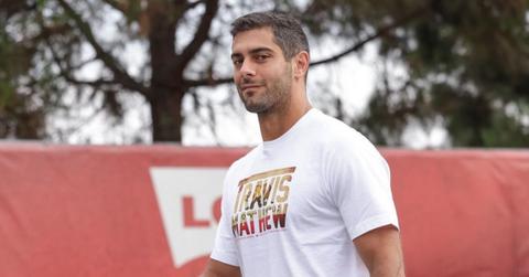 Jimmy Garoppolo walking wearing a Travis Mathew shirt.