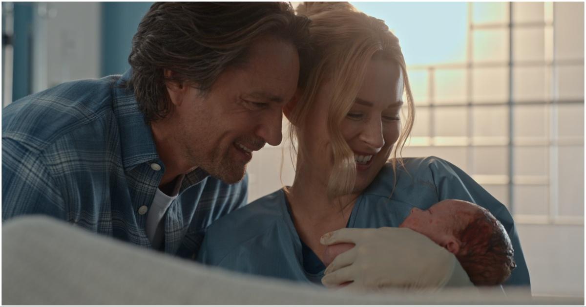 jack and mel holding a baby