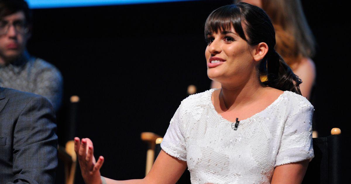 Lea Michele explaining something at an event for 'Glee.'