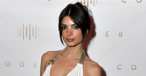 Emily Ratajkowski in a gold and white outfit.