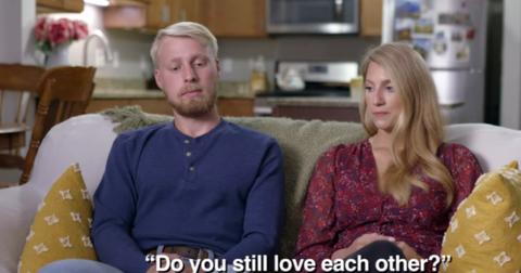 Ethan and Olivia Plath sitting on a couch and discussing their relationship