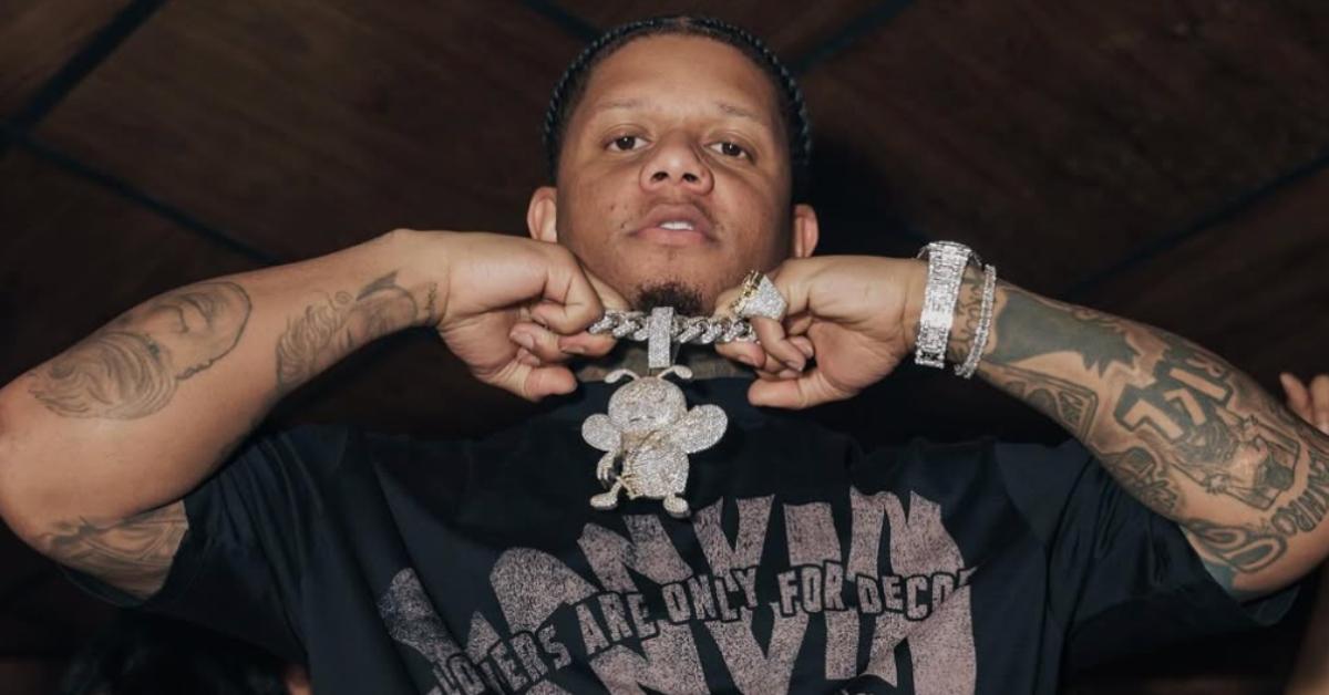 Yella Beezy holds up a necklace