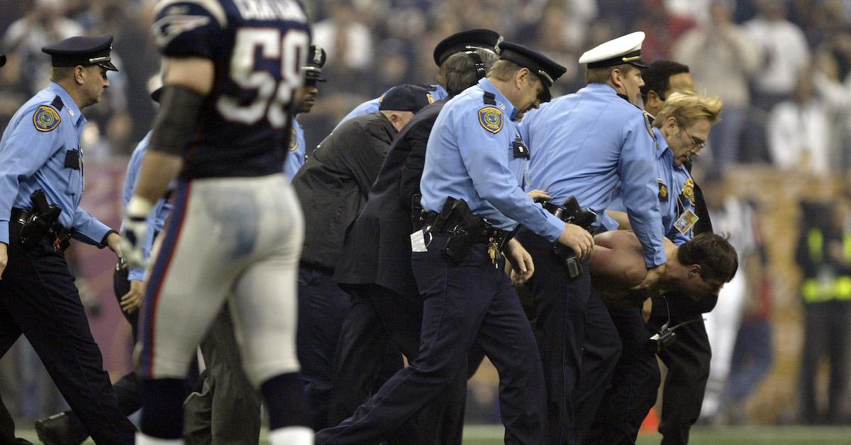 The police carry a streaker off the field during Super Bowl XXXVIII between the New England Patriots and the Carolina Panthers at Reliant Stadium on Feb. 1, 2004 in Houston