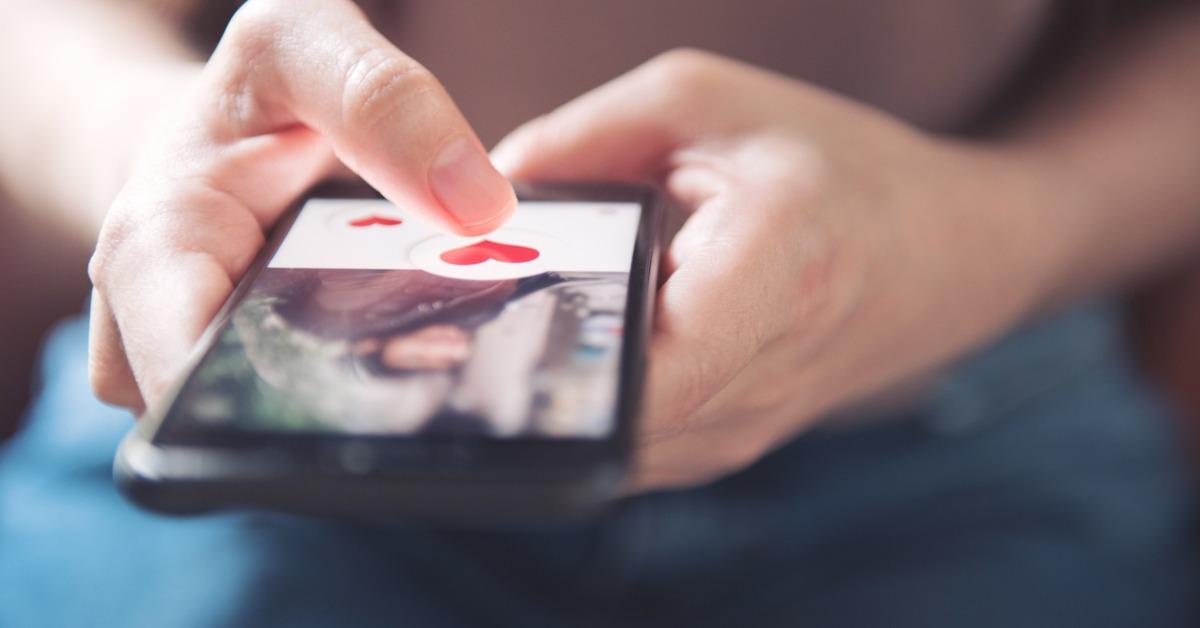 finger of woman pushing heart icon on screen in mobile smartphone picture id