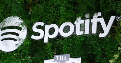 Spotify logo against trees.