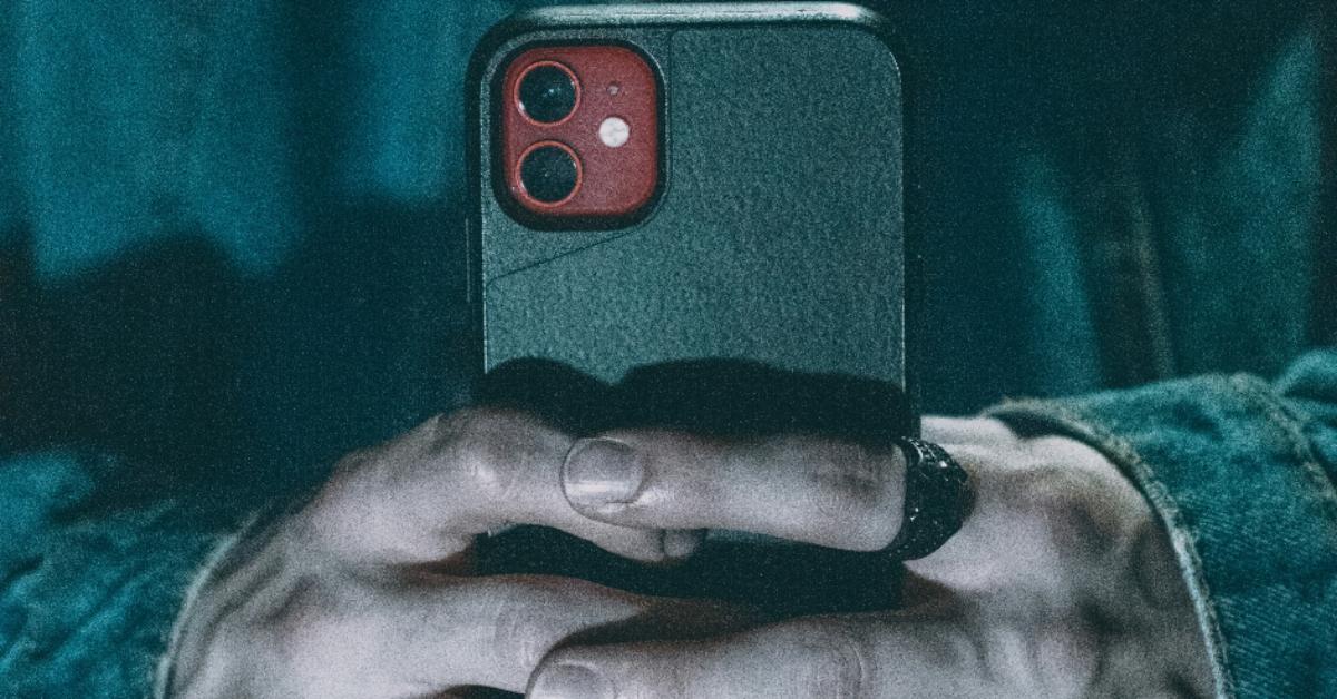 Pair of hands holds a cell phone