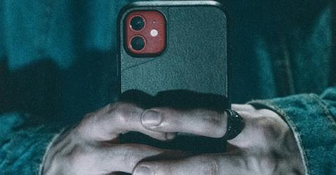 Pair of hands holds a cell phone