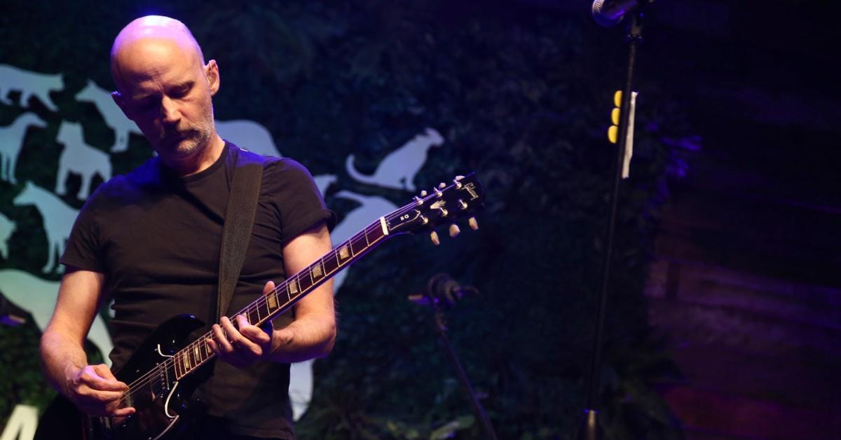 Moby performing while playing guitar