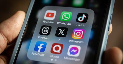 A TikTok app on a phone with other social media apps.