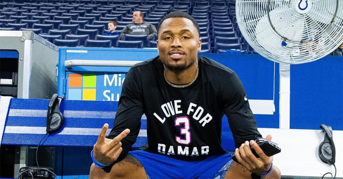 Isaiah Rodgers wearing a Damar Hamlin shirt and sitting on the Indianapolis Colt's bench. 