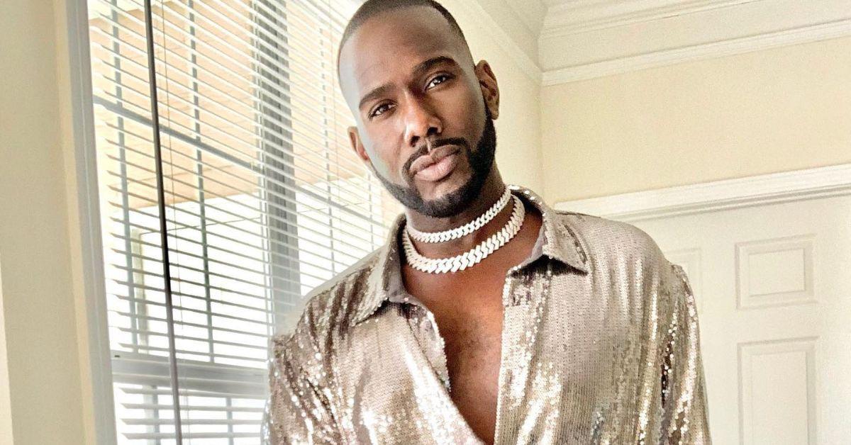 Nicco Annan posing in a sequined shirt and chain necklaces.